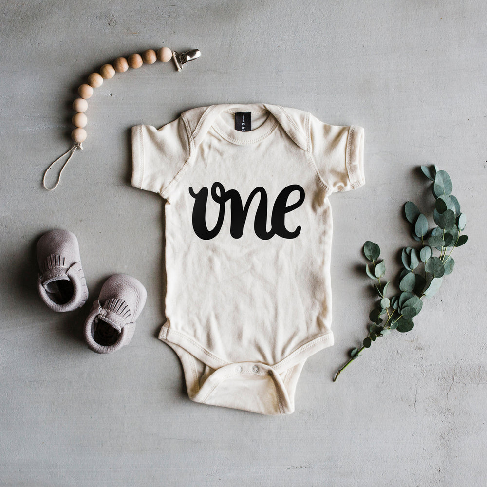 
                
                    Load image into Gallery viewer, &amp;quot;One&amp;quot; Baby Bodysuit // Cream
                
            