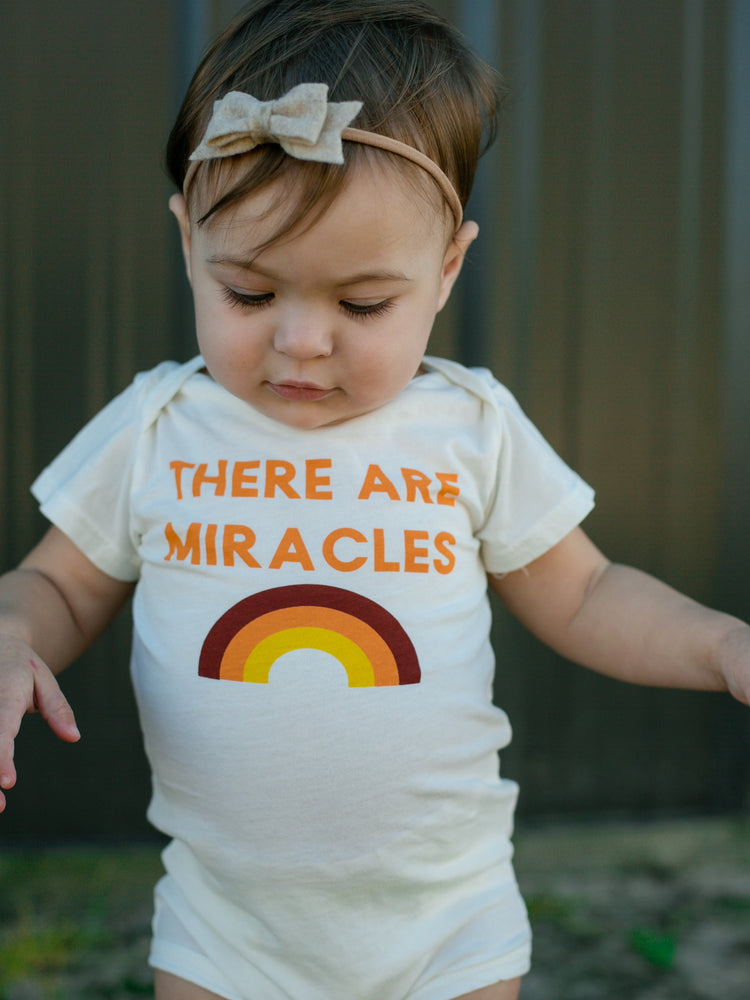 
                
                    Load image into Gallery viewer, NEW! &amp;quot;There Are Miracles&amp;quot; Organic Onesie // Cream
                
            